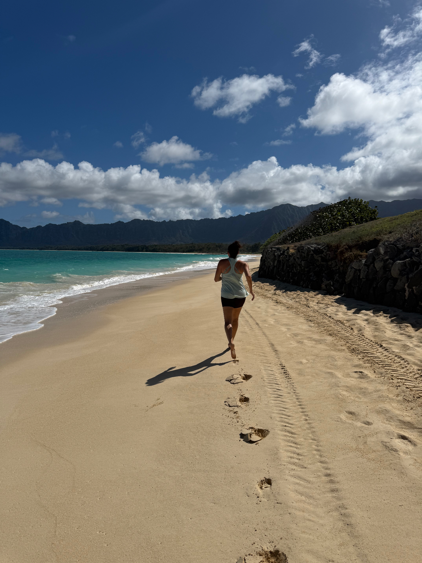 Lisa running barefoot on a Hawaiian beach